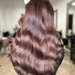 Foto di donna con capelli lunghi castano scuro mogano o violino